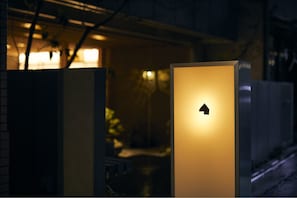 A brightly lit entrance with a directional arrow sign.