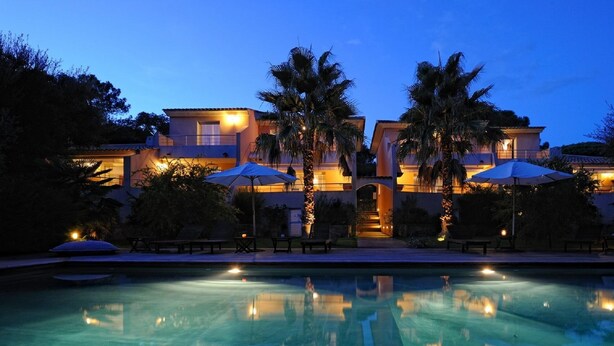 A multi-story resort with a swimming pool, palm trees, and outdoor seating areas. -  high standing *** villa with heated pool, near downtown (Porto-Vecchio)