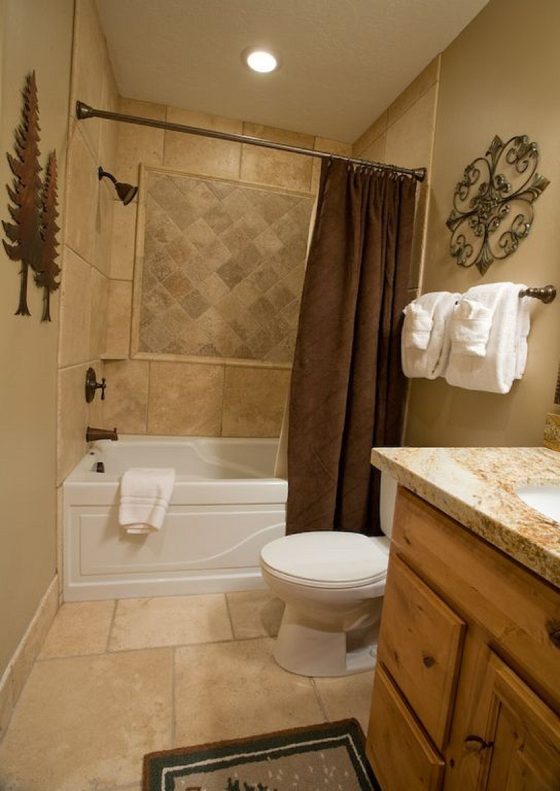 A bathroom with a bathtub, toilet, and vanity.