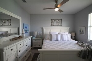 A bedroom with a bed, dresser, nightstands, and a ceiling fan. - THE PEARL at the Emerald Coast 1 Duplex (Santa Rosa Beach)