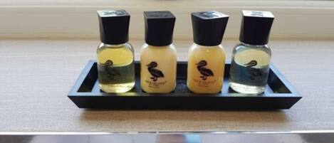 Four perfume bottles on a black tray.