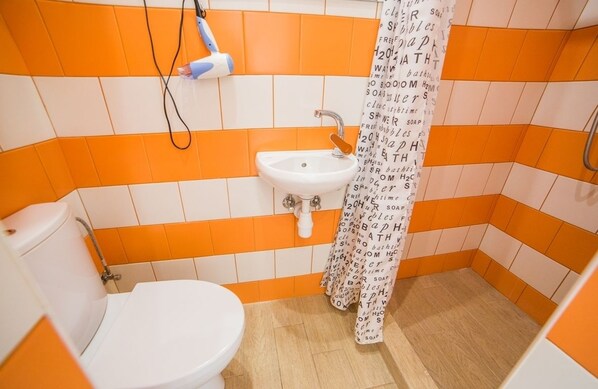 A bathroom with a white toilet, a sink, and a shower curtain with text. - Smart Apartment Kulisha 29a (Lviv)