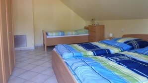 A bedroom with two beds, a dresser, and a radiator. - "Nice living in Mainz" Apartment Gisela & Jürgen Will  (Gonsenheim)