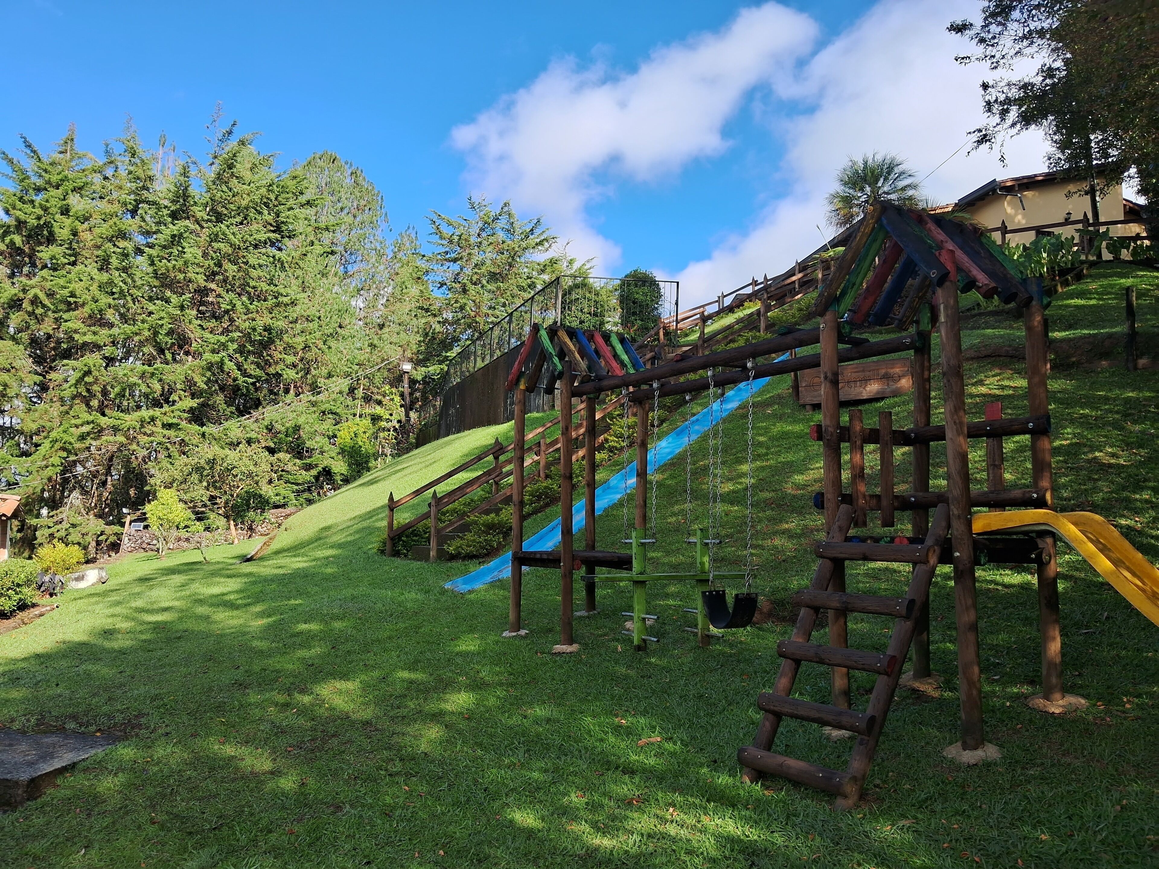 A playground with a slide and climbing structures.