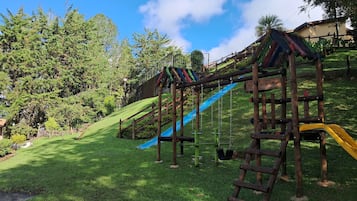 A playground with a slide and climbing structures.