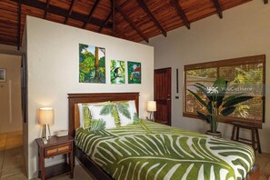 A bedroom with a bed, nightstands, a window with a view, and three wall-mounted paintings. - 3BR Home, Valley Views, 15 Minutes Drive to Dominical (Dominical)