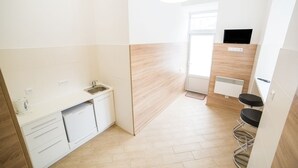 A modern kitchen with white cabinets, a built-in oven, and a sink. - Smart Apartment Kulisha 29v (Lviv)
