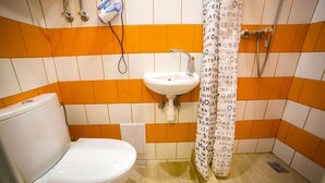 A bathroom with a toilet, sink, and shower. - Smart Apartment Chornovola 21a (Lviv)