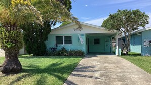 A single-story house with a light blue exterior, a front porch, and a well-maintained lawn. - Sunsational Seahorse- Nice and Relaxing
2/2 Sleeps 6 (New Port Richey)