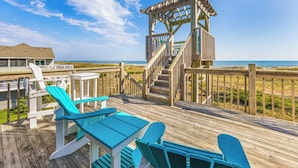 A wooden deck with a gazebo, chairs, and a table overlooking the beach. - Oceanfront Dog Friendly Home w/ Pool, Hot Tub, Game Room, Direct Beach Access (Waves)