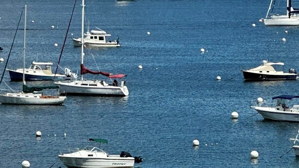 A marina with various boats, including sailboats and motorboats, anchored in calm waters. - Seaglass Village Wells #426.Near Clubhouse. Same Time Next Year Promotion, NOW! (Wells)