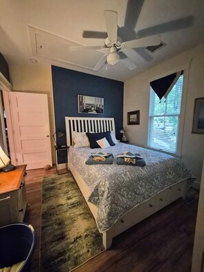 A bedroom with a bed, a ceiling fan, a window with blinds, a door, and a rug. - Seaglass Village Wells #426.Near Clubhouse. Same Time Next Year Promotion, NOW! (Wells)