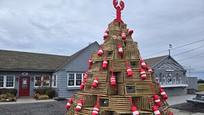 A building with a red door and windows, surrounded by gravel and plants. - Seaglass Village Wells #426.Near Clubhouse. Same Time Next Year Promotion, NOW! (Wells)