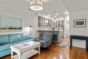 Relax in this stylish living space with a comfortable sofa, coffee table, and armchair.