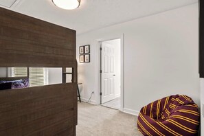 Relax in a serene space with a bean bag chair and framed artwork.