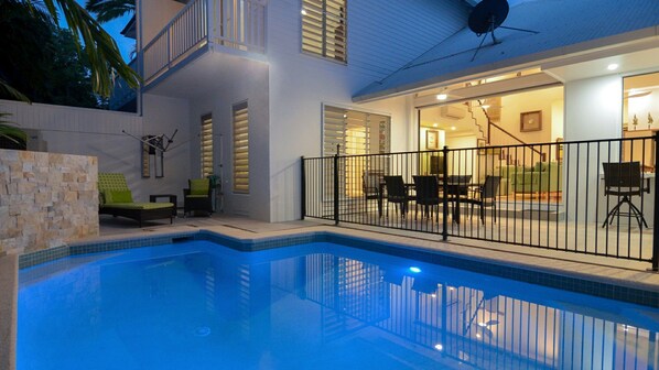 Enjoy a refreshing swim in the pool surrounded by a covered patio with comfortable seating.