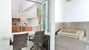 Enjoy cooking in this well-equipped kitchen with stove and oven, sink, and ample storage.