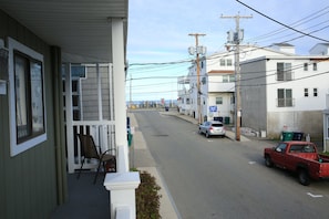 Houses line a quiet suburban street with attached garages and front porches.