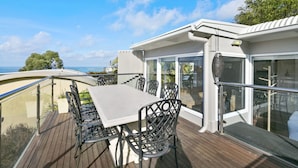 A deck with a table and chairs, overlooking a scenic view. - On The Deck (Lorne)