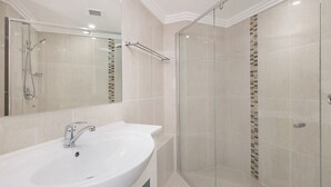 A modern bathroom with a large sink, a glass shower enclosure, and a tiled wall with a mosaic pattern. - San Simeon 6 - Ground Floor, Absolute Beachfront at Tugun! (Tugun)