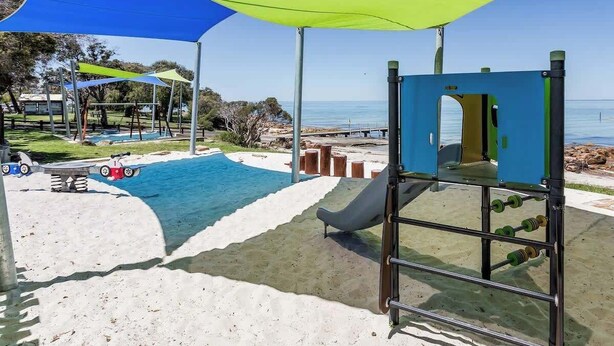 A playground with a slide, swings, and a climbing structure. - All Seasons—Coastal Charm Steps to Beach & Town (Dunsborough)