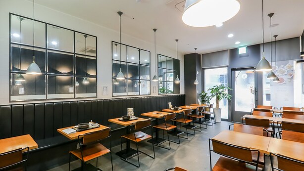 A restaurant interior with booth seating, pendant lighting, and a large window. - Residence Hotel LINE (Daejeon)