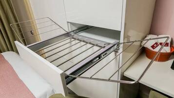 Guests can hang their clothes on the drying rack and store essentials in the nearby basket.