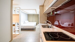 A compact hotel room with a kitchenette, a bed, and a bathroom. - Residence Hotel LINE (Daejeon)