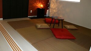 A room with tatami mats, a low table, and cushions. - Sun Flower (Onna)