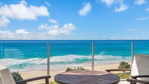 A beach view with a wooden deck and two chairs, overlooking the ocean. - Aqua Solai 9 - Absolute Beachfront Tugun - Min. 3 night stays - Linen Provided (Tugun)