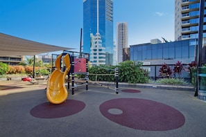 Kids can play on the slide and climbing structure in this outdoor play area.
