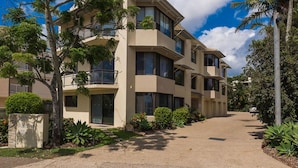 A multi-story residential building with balconies and a paved driveway. - Noosaville River Front  - Watch the colors over the water (Noosaville)