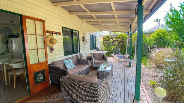 A covered outdoor area with wicker furniture, a dining table, and chairs. - The Batch - Burrum Heads - Walk To Beach - 2BR - Pets Welcome (BURRUM HEADS)