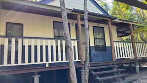 A two-story building with a balcony, wooden railings, and a covered porch area. - 8 Orania Court - Rainbow Shores. Privacy, Peace and Quiet (RAINBOW BEACH)
