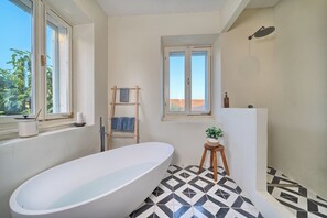 Combined shower/tub, hair dryer, towels, soap