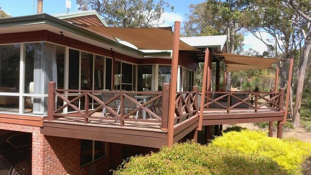 A two-story house with a wooden deck and a covered outdoor seating area. - The Nest—Tranquil Bush Retreat near Dunsborough (Yallingup)