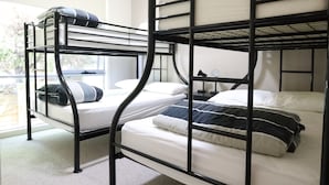 A bunk bed room with two beds, a window, and a nightstand. - Craiglee (Lorne)