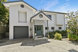 A two-story house with a garage, a covered porch, and a front door. - Fernview (Lorne)