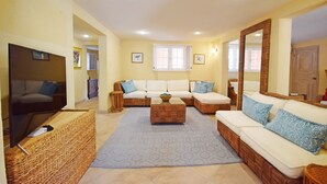 A spacious living room with a large sofa set, a coffee table, and a television. - 3 Min Walk to Beach - Blessed Manor (4 Bed House) (Hastings)