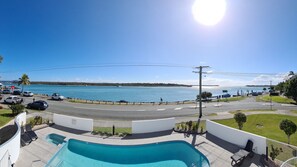 A pool with a view of a road and a body of water. - LOCATION DOESN'T GET ANY BETTER THAN THIS (Noosaville)