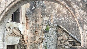 An ancient stone structure with a partially intact archway, overgrown vegetation, and visible stone walls. - Beautiful quiet villa (4p), private pool and great sea views (Kirianna)
