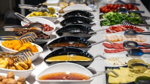 A buffet table with various food items and utensils. - City Life Demir Hotel (Fethiye)
