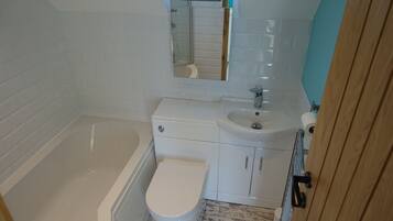 Combined shower/bathtub, hair dryer, towels, toilet paper