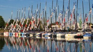 A marina with multiple sailboats docked, each with various flags and banners. - 7 Cottages in 100 acres, heated pool. Near Pont Aven, Concarneau, beaches 15km (Bretagne)