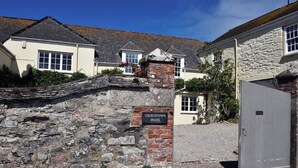 A stone wall with a sign reading "CHURCHTOWN HOUSE". - Stunning coastal annex with spectacular sea views (Perranuthnoe)