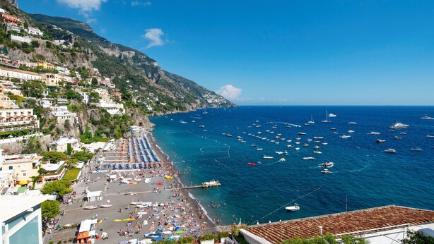 A coastal town with a beach, boats, and buildings on a hillside. - Casa Margherita ..... Positano, perfect location for your holiday in Positano (Positano)