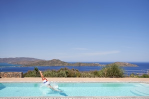 An infinity pool, a heated pool, sun loungers