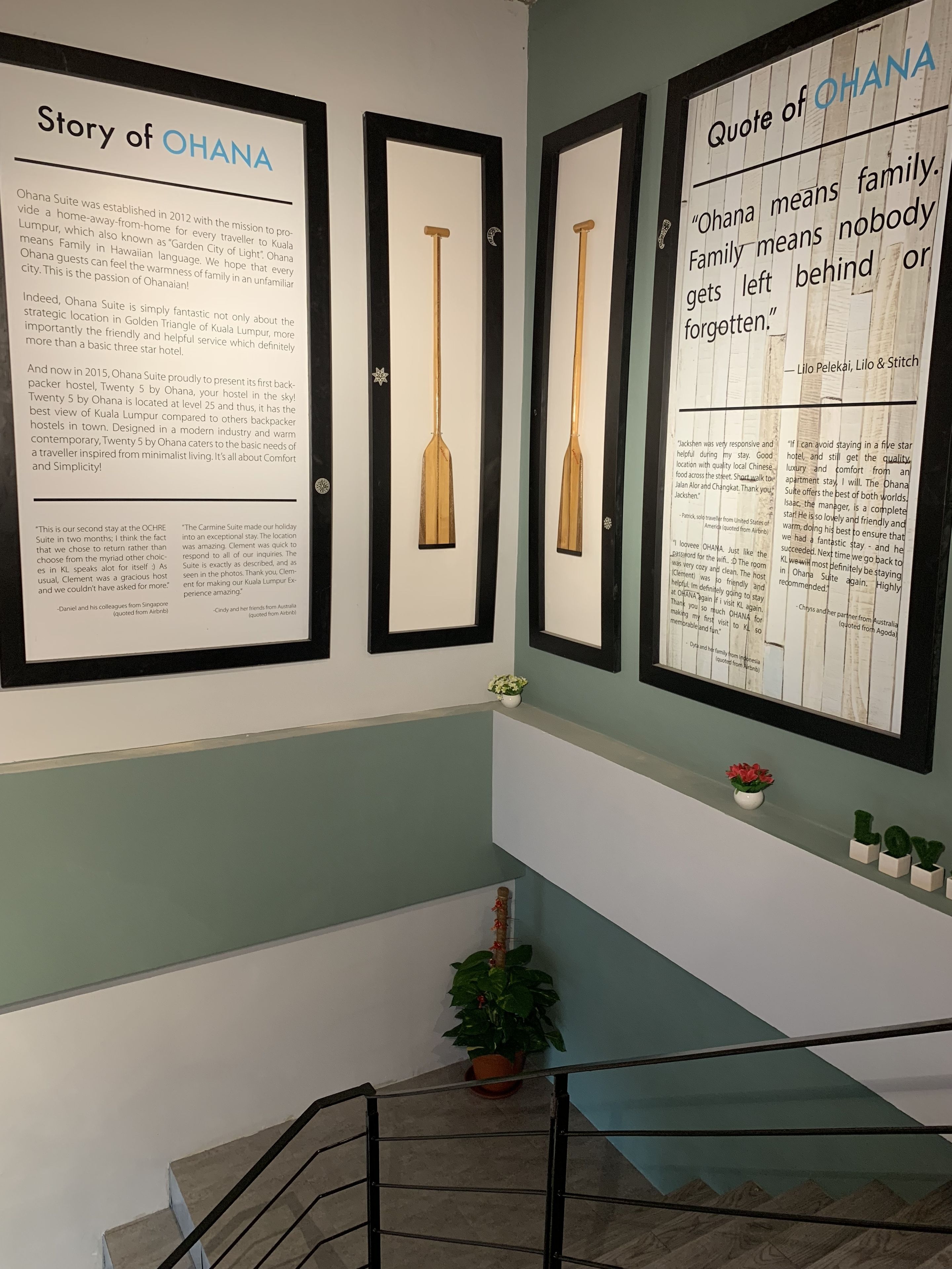 Three framed documents on a wall, each with text and a wooden paddle.