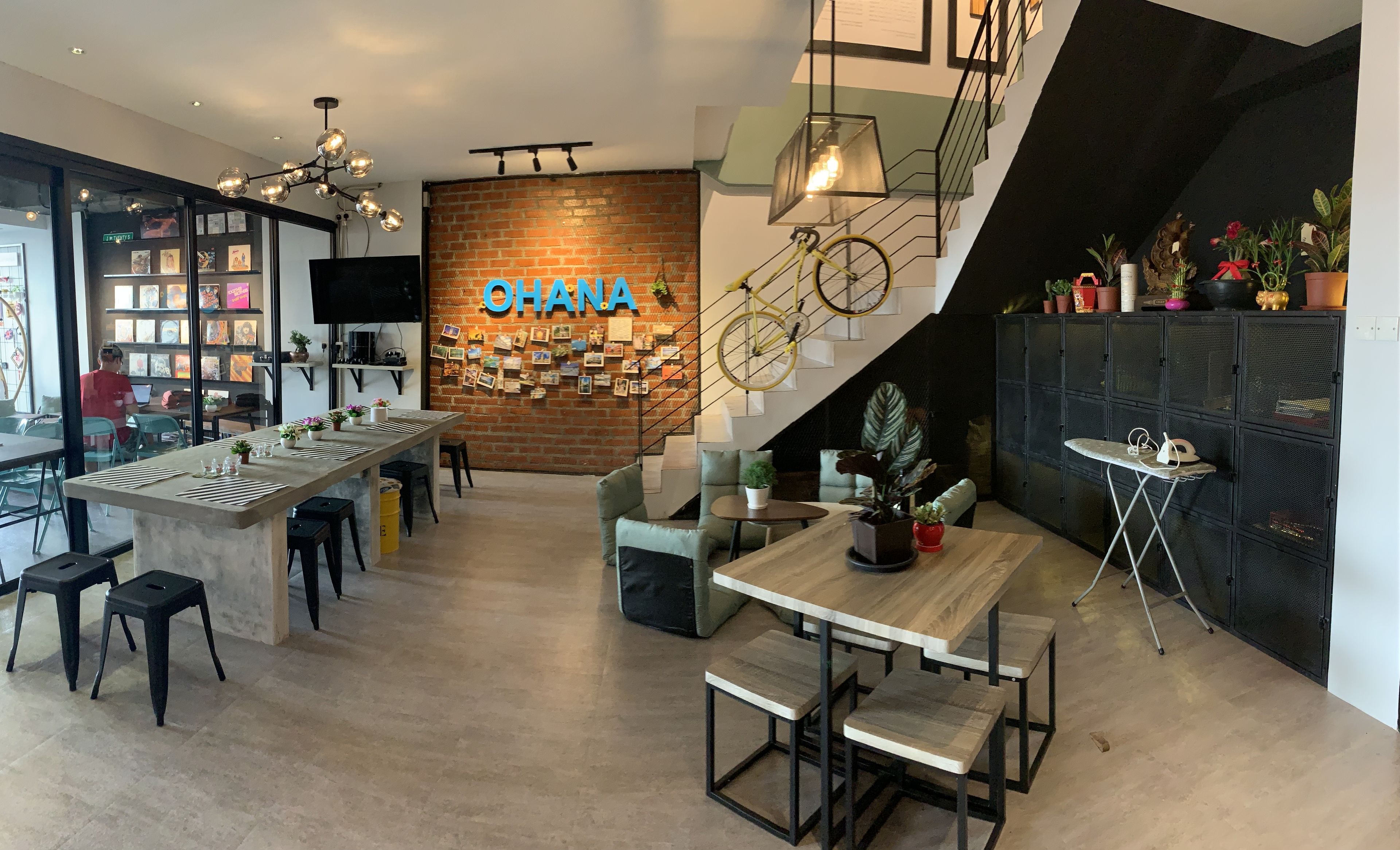 A modern interior with a bar area, seating, and a staircase.