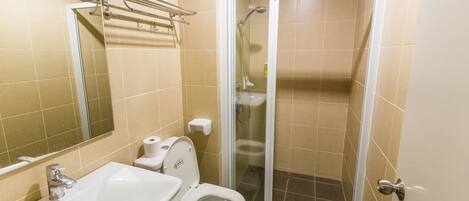 A bathroom with a sink, toilet, and shower.